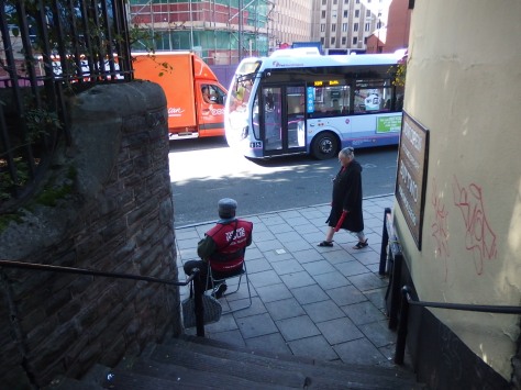 Street scene in Bristol with a Big Issue seller